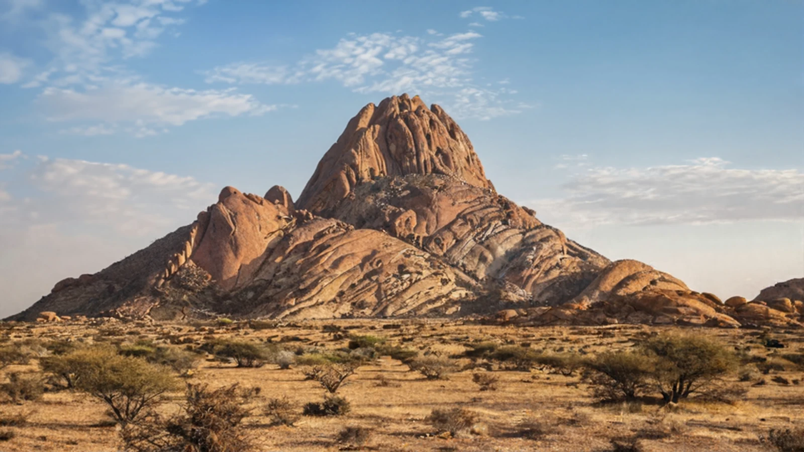 Spitzkoppe artwork showing the sunlit mountain above a dry, open plain